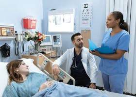 pexels-photo-6129681-6129681 Doctors and nurse discussing patient's treatment in a hospital room.